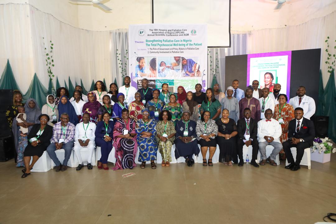 Full group of delegates and committee members on stage at the conference