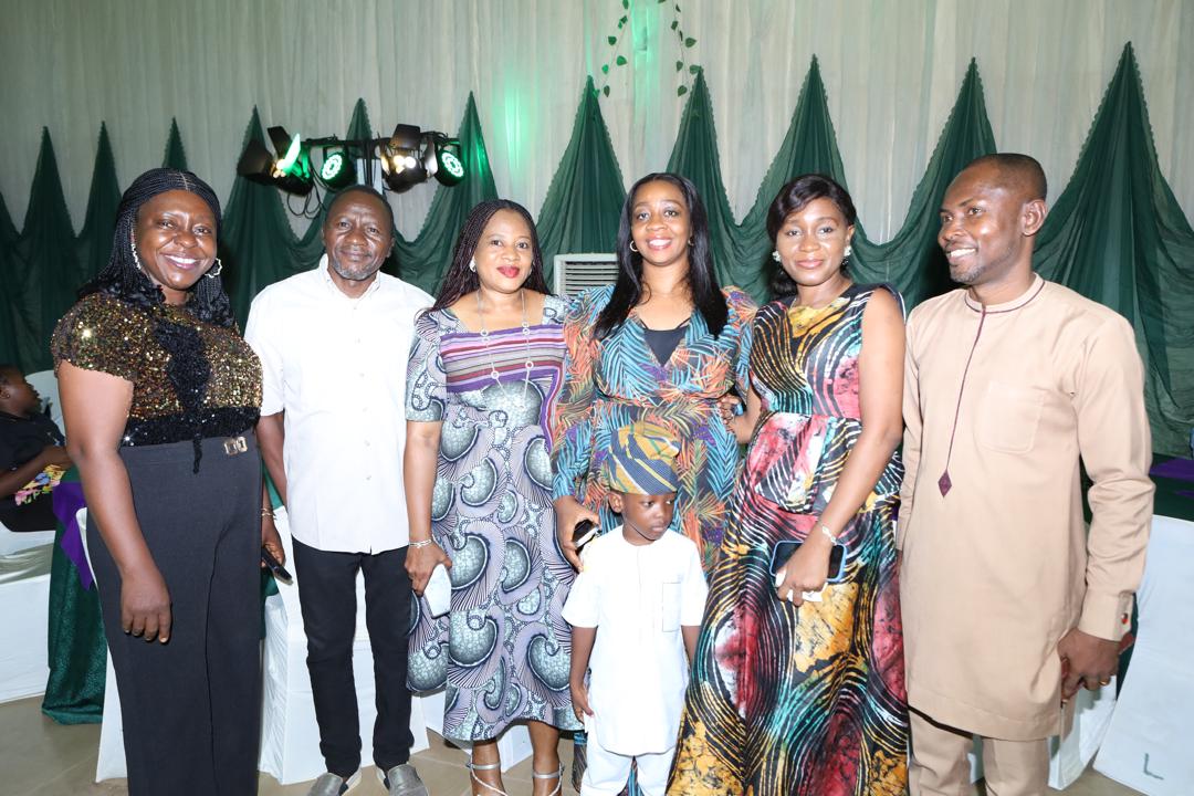 A group of six delegates posing together at the dinner