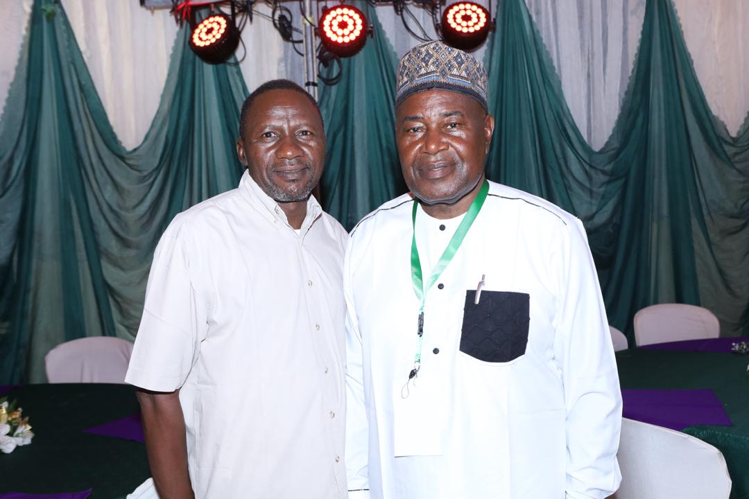 Two delegates posing together on stage